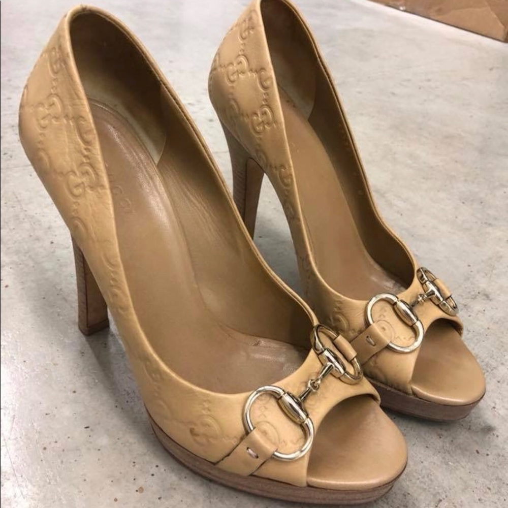 Worn Gucci embossed pumps